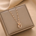 Gold-tone swan charm pendant necklace with linked chain