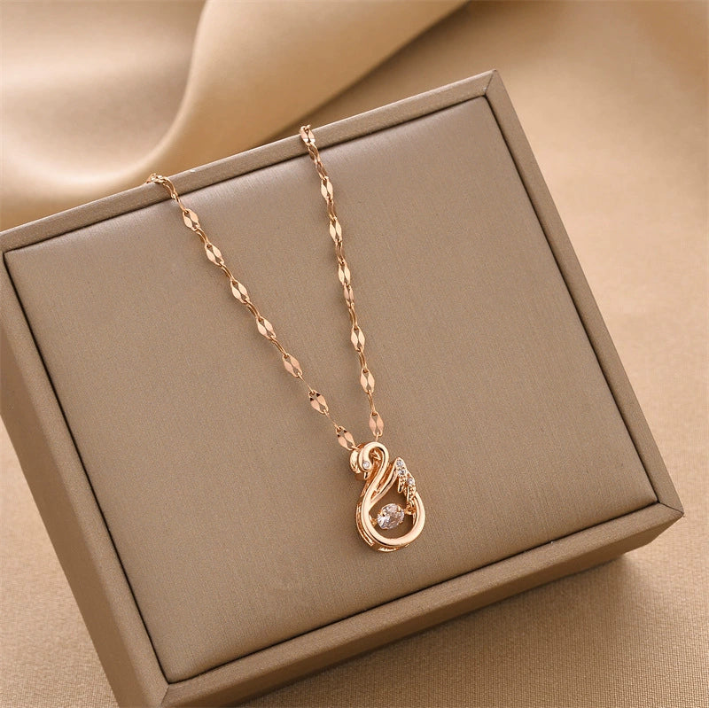 Gold-tone swan charm pendant necklace with linked chain