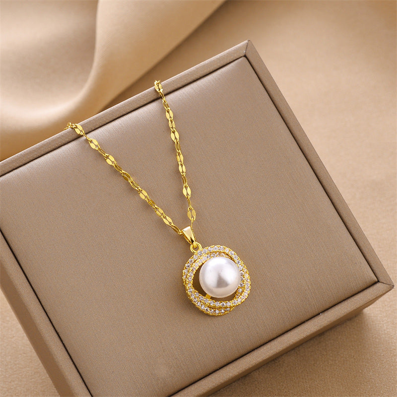Gold charm pendant necklace with round white pearl bead and sparkling rhinestone halo