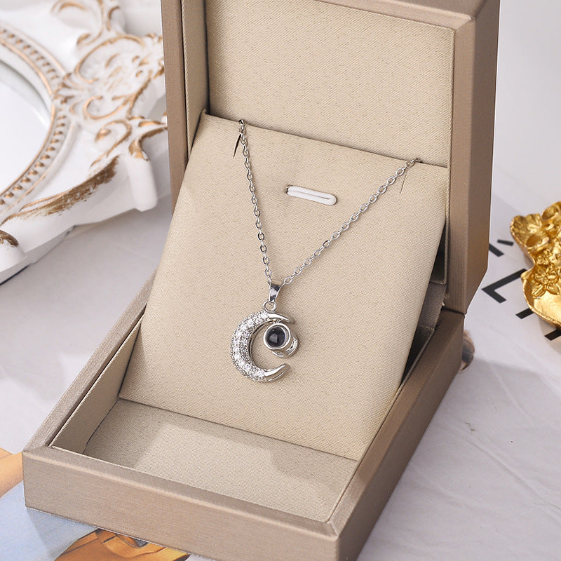 Silver moon charm pendant necklace with rhinestone crescent on chain