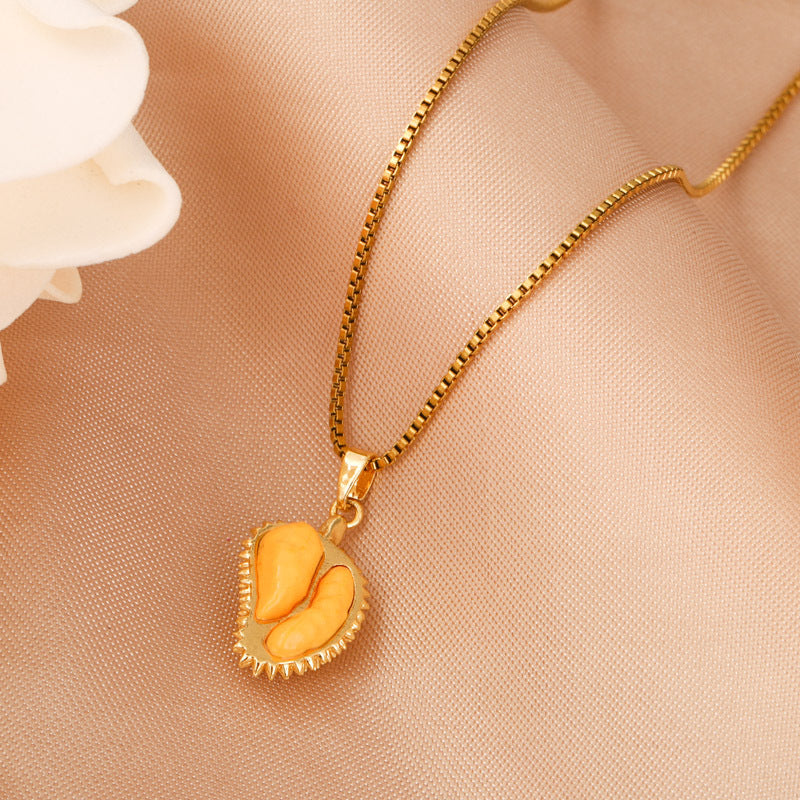 Gold-tone pendant necklace with open durian pod charm and resin segments