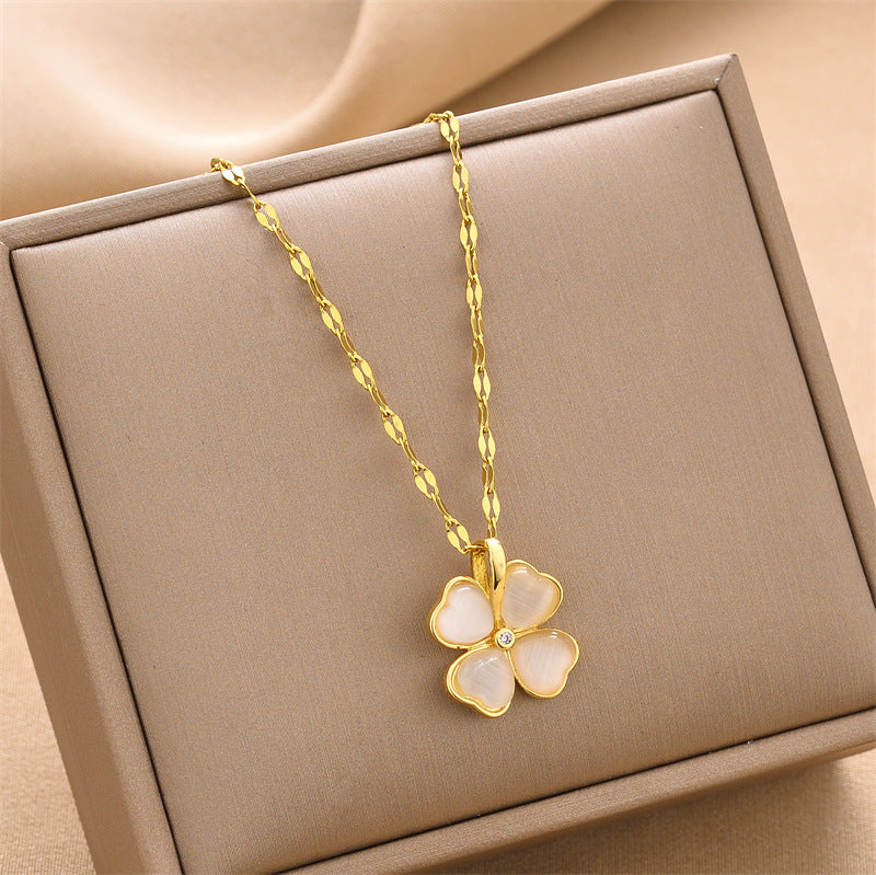 Gold flower pendant necklace with small crystal accent on link chain
