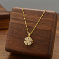 Gold-tone flower pendant necklace with petal floral charm on link chain