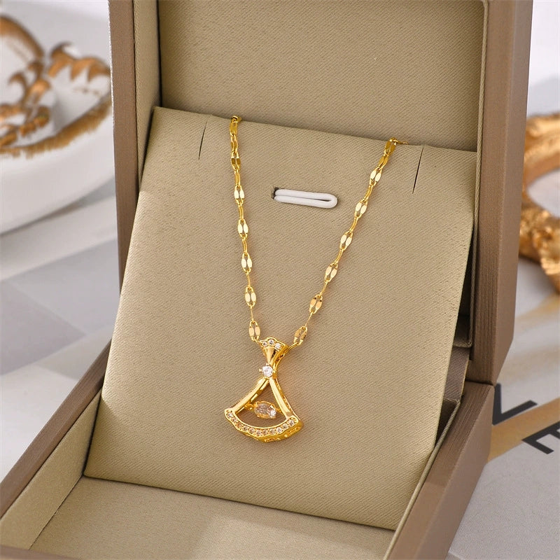 Gold-tone petal pendant necklace with teardrop charm and clear stone detailing.
