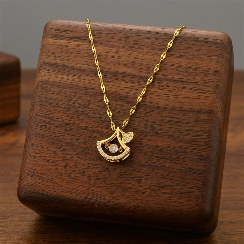 Gold ginkgo leaf duo pendant necklace with curved crescent design and clear stones