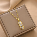 Gold-tone pendant necklace with three green bead charms, shown in gift box