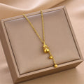 Gold mini gourd charm pendant necklace with long chain and small dangling bead charms