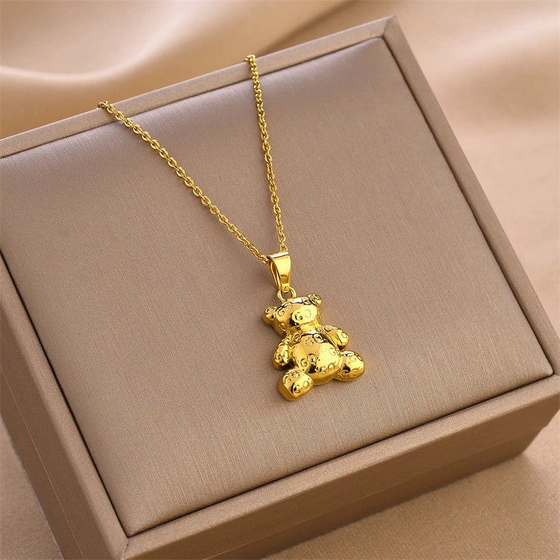 Gold bear pendant necklace with link chain, displayed in jewelry box