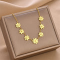 Gold wildflower charm necklace with five-petal flower links and adjustable chain