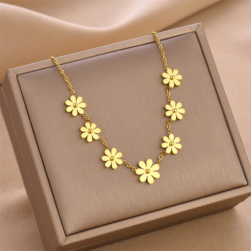 Gold wildflower charm necklace with five-petal flower links and adjustable chain