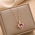 Rose gold heart pendant necklace with purple gemstone, chain links visible