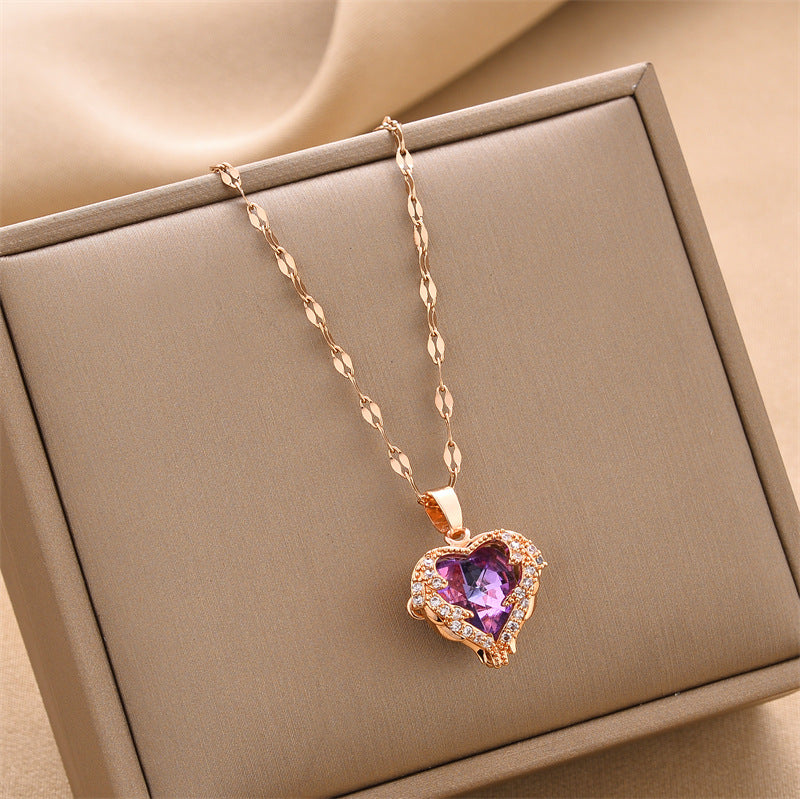 Rose gold heart pendant necklace with purple gemstone, chain links visible