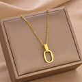 Gold O-shaped charm necklace with linked chain and oval open ring pendant