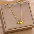Gold-tone triple ball charm necklace with linked chain, in beige gift box