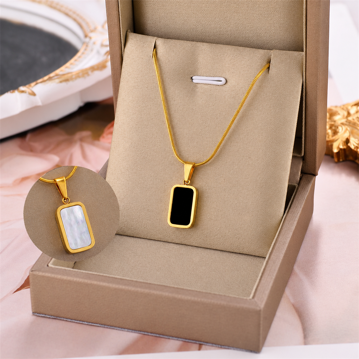 Gold square charm necklace with black enamel pendant on thin chain, gift box display