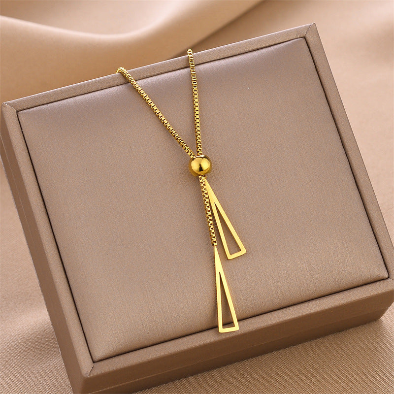 Gold double triangle charm necklace with ball pendant and two geometric triangles