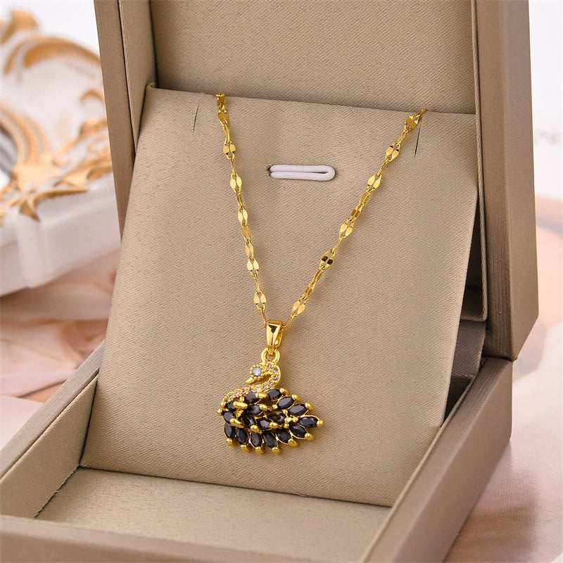 Gold-tone wing pendant necklace with black center stones and clear accents