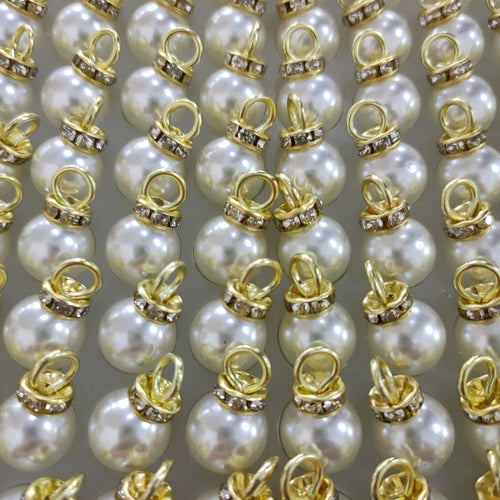 Faux pearl charm pendant set with gold-tone loops and off-white resin pearls