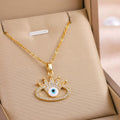 Gold eye charm pendant necklace with crown detail and sparkling bezel