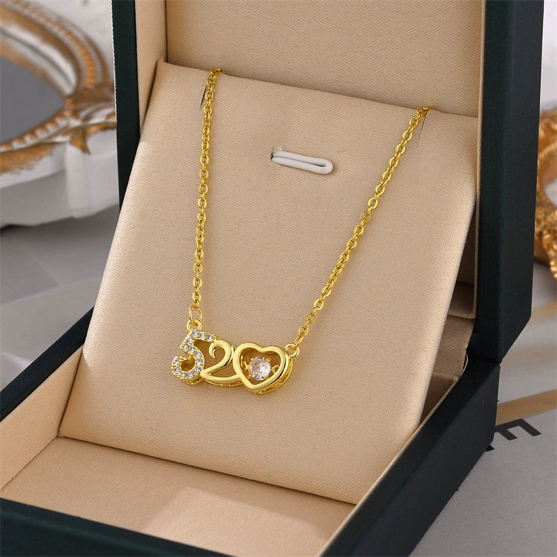 Gold-tone 520 heart charm necklace with round crystal center