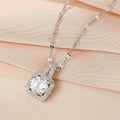 Silver-tone square pendant necklace with large clear center stone and halo setting