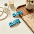 Set of blue metal snap hair clips with geometric cutout, for women