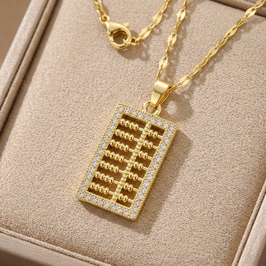 Gold-tone abacus charm necklace with round clasp and square crystal pendant