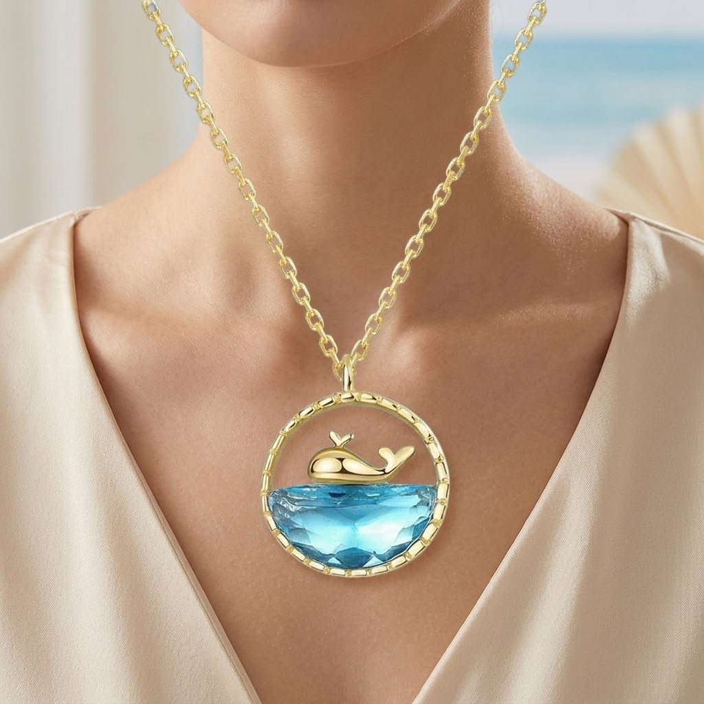 Gold mini shark ocean pendant necklace with oval blue stone and shark silhouette