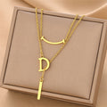 Gold-tone letter D charm necklace with chain and bar drop
