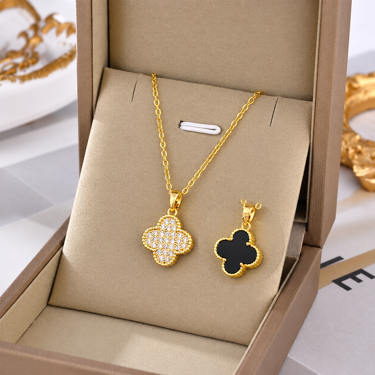 Gold-tone floral clover pendant necklace with sparkle charm and matching stud earrings