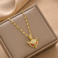 Gold-tone fox head charm necklace with red enamel and rhinestone details