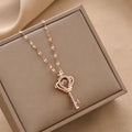 Rose gold-tone charm key necklace with crown-heart pendant