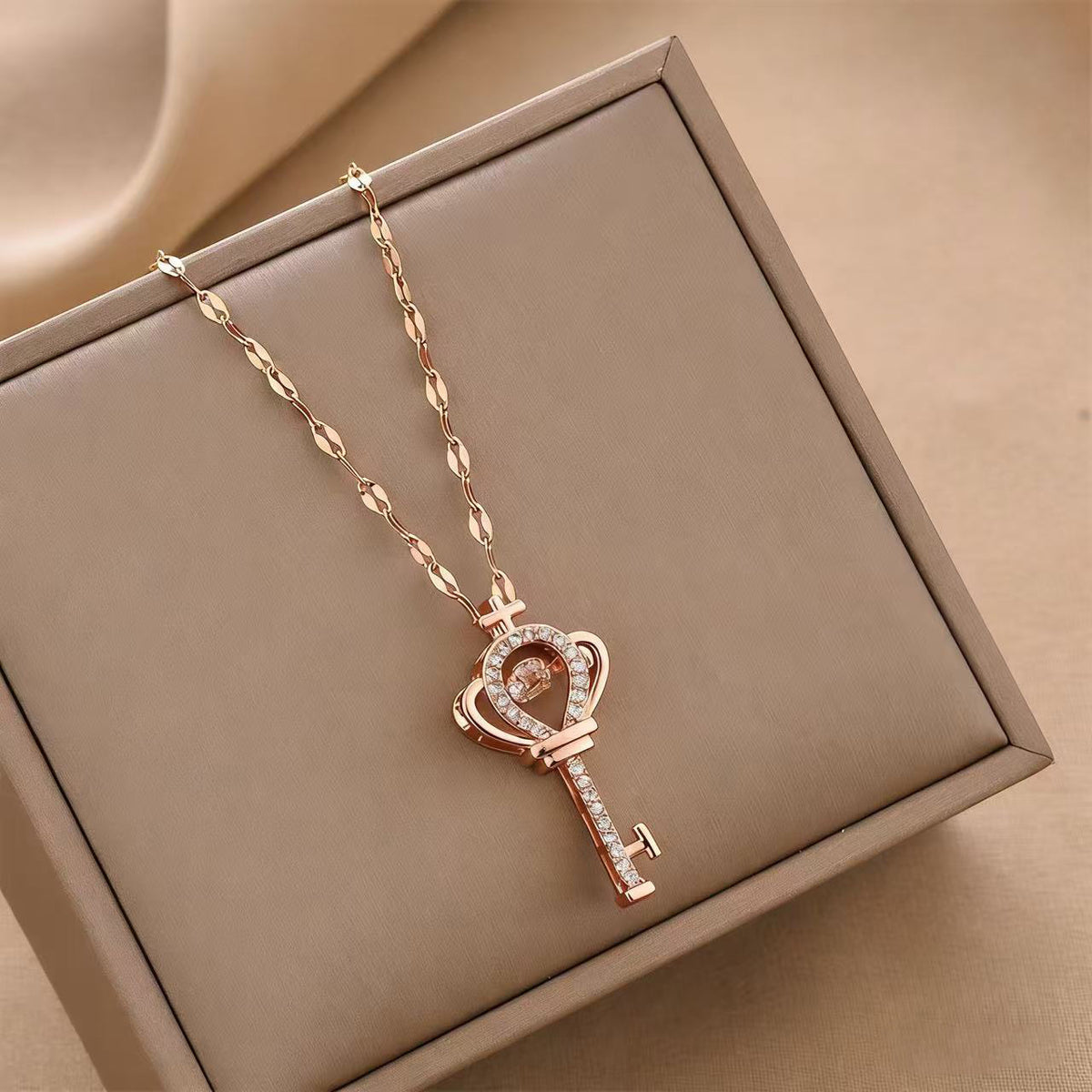 Rose gold-tone charm key necklace with crown-heart pendant