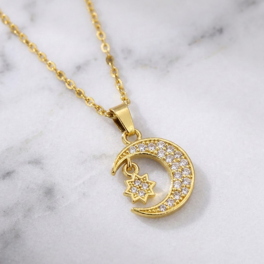 Gold crescent moon and star charm necklace with clear stones