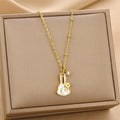 Gold-tone chain pendant necklace with hanging petal flower charm and crystal loop