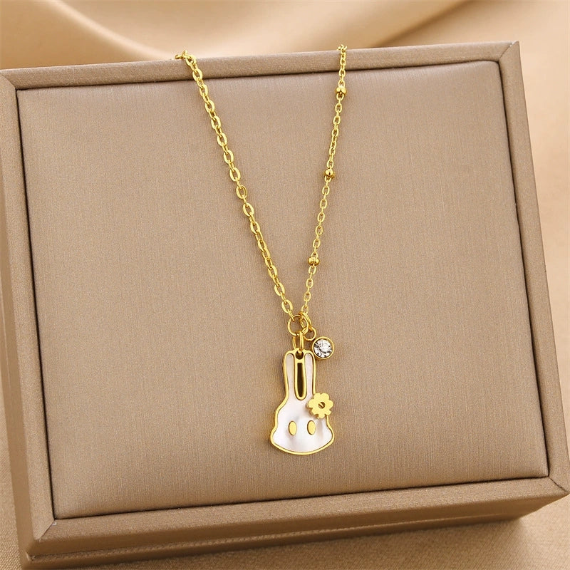 Gold-tone chain pendant necklace with hanging petal flower charm and crystal loop
