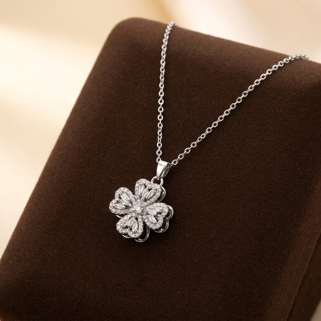 Close-up silver-tone flower petal pendant necklace with sparkly floral charm