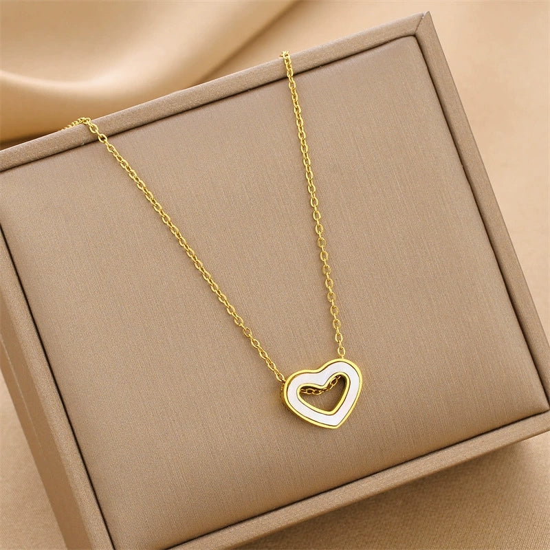 Heart pendant necklace with hollow heart design and gold-tone chain