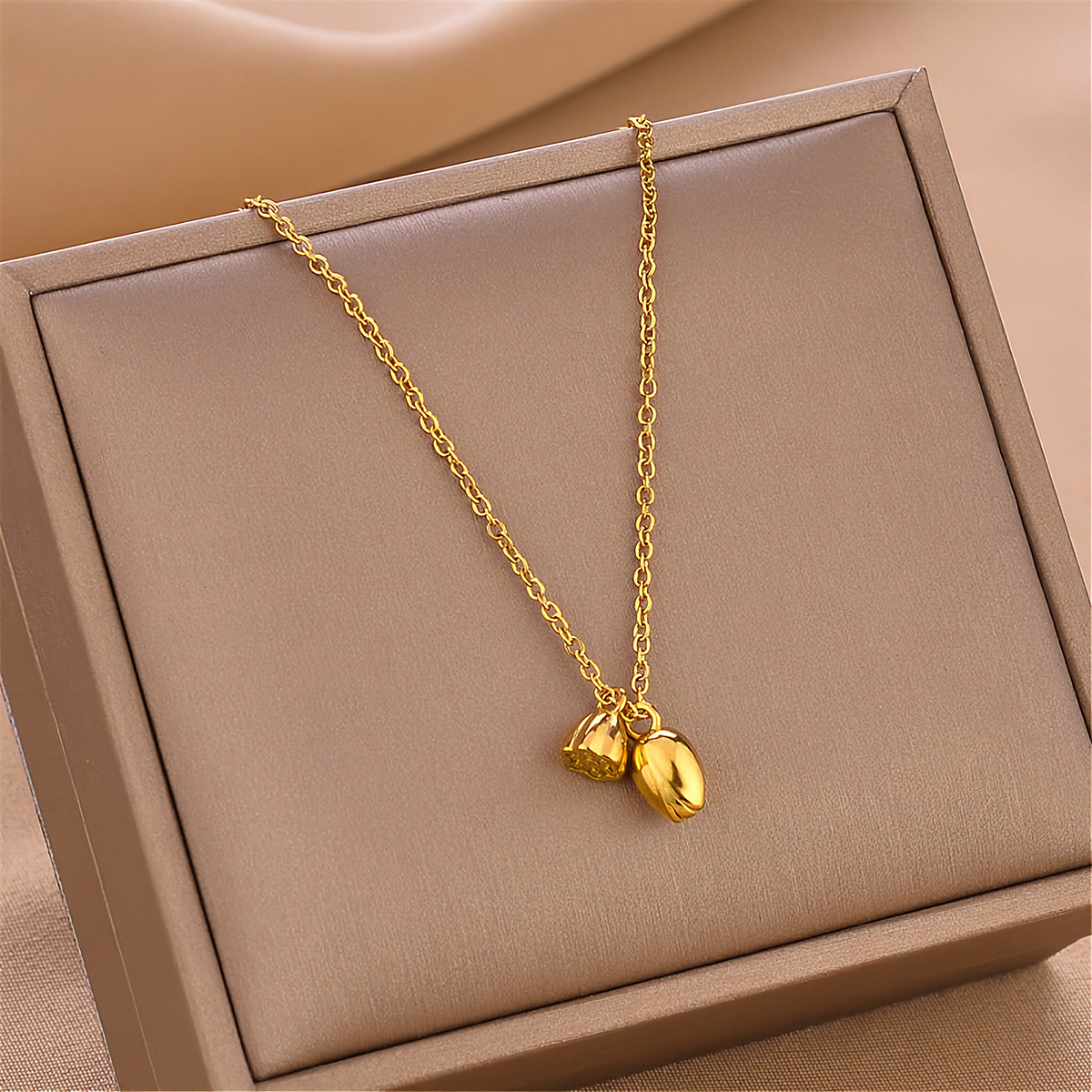 Gold-tone lotus root pendant necklace with V-shaped chain drape