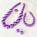 Purple faux pearl jewelry set with beaded necklace, bracelet, earrings, and ring