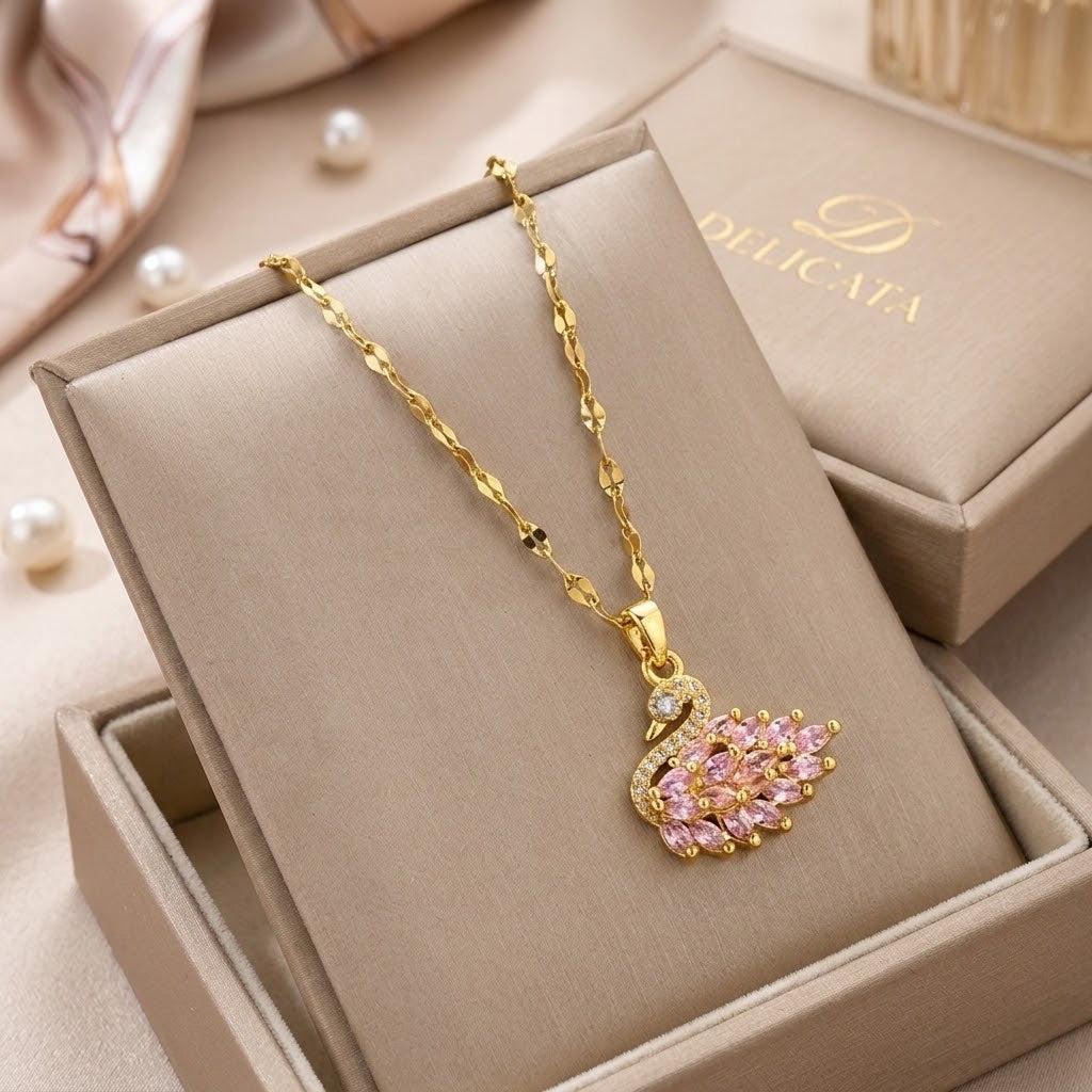 Gold-tone chain wing pendant necklace with pink stones and a small clear center crystal