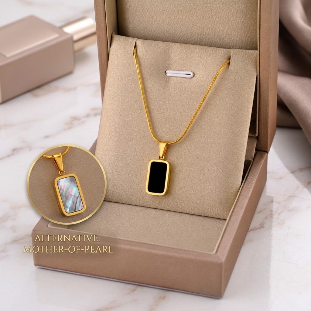 Gold square charm necklace with black enamel pendant and iridescent mother-of-pearl charm shown