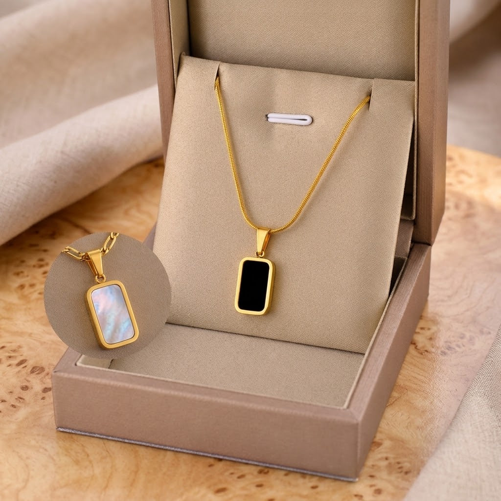 Gold square charm necklace with black enamel pendant and iridescent square charm, boxed
