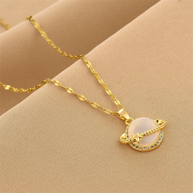 Gold-tone star globe charm necklace with white globe pendant and star accent