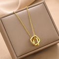 Gold double-square charm necklace with two linked chains and a circular square pendant