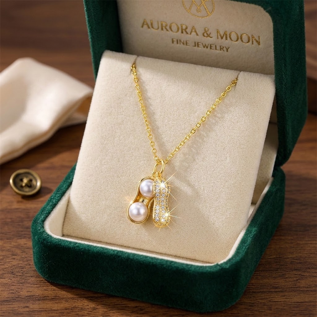 Gold-tone peanut-shaped pearl charm necklace with white pearl beads and crystal sparkle