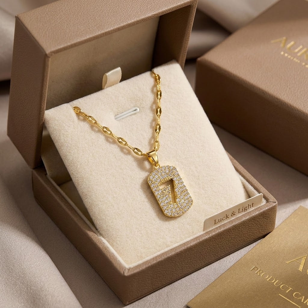 Gold-tone number 7 charm necklace displayed in gift box with sparkling pendant