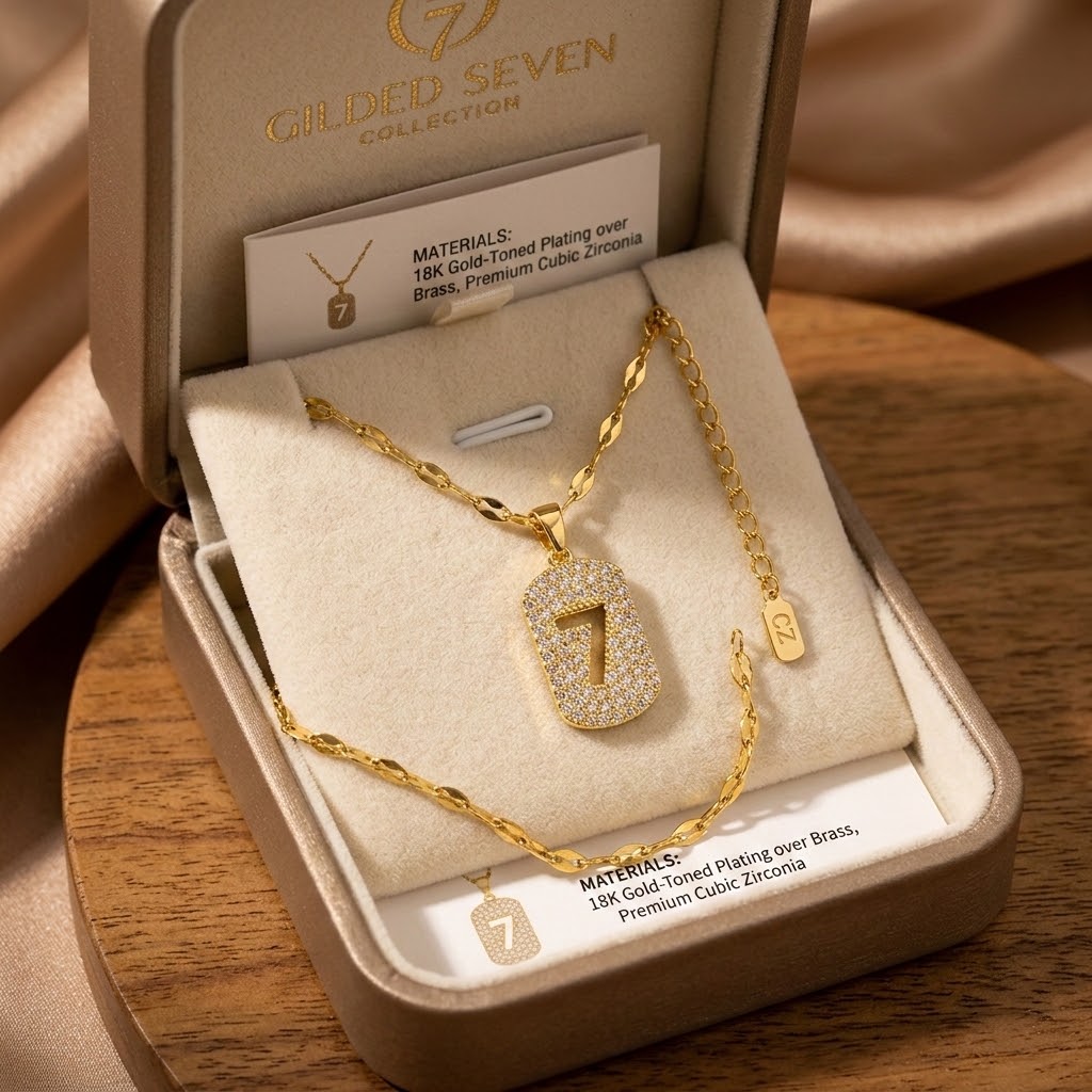Gold-tone charm necklace set with number 7 pendant on chain, in gift box