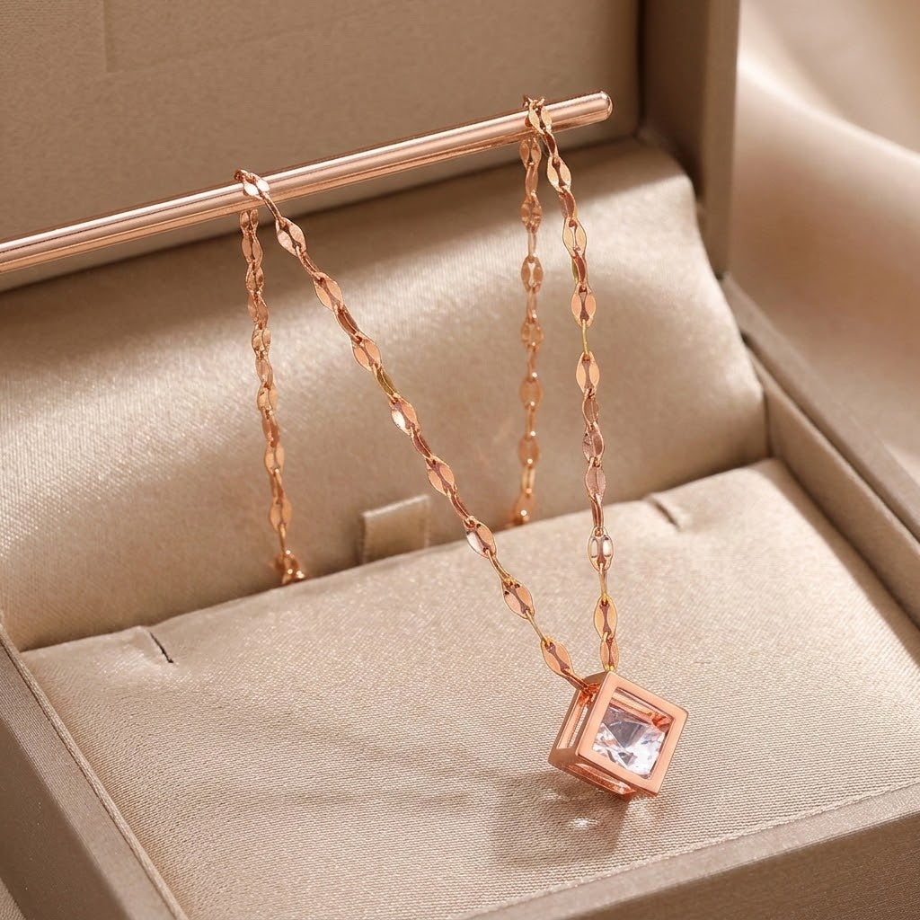 Rose gold square charm necklace with pink cubic centerpiece on flat link chain