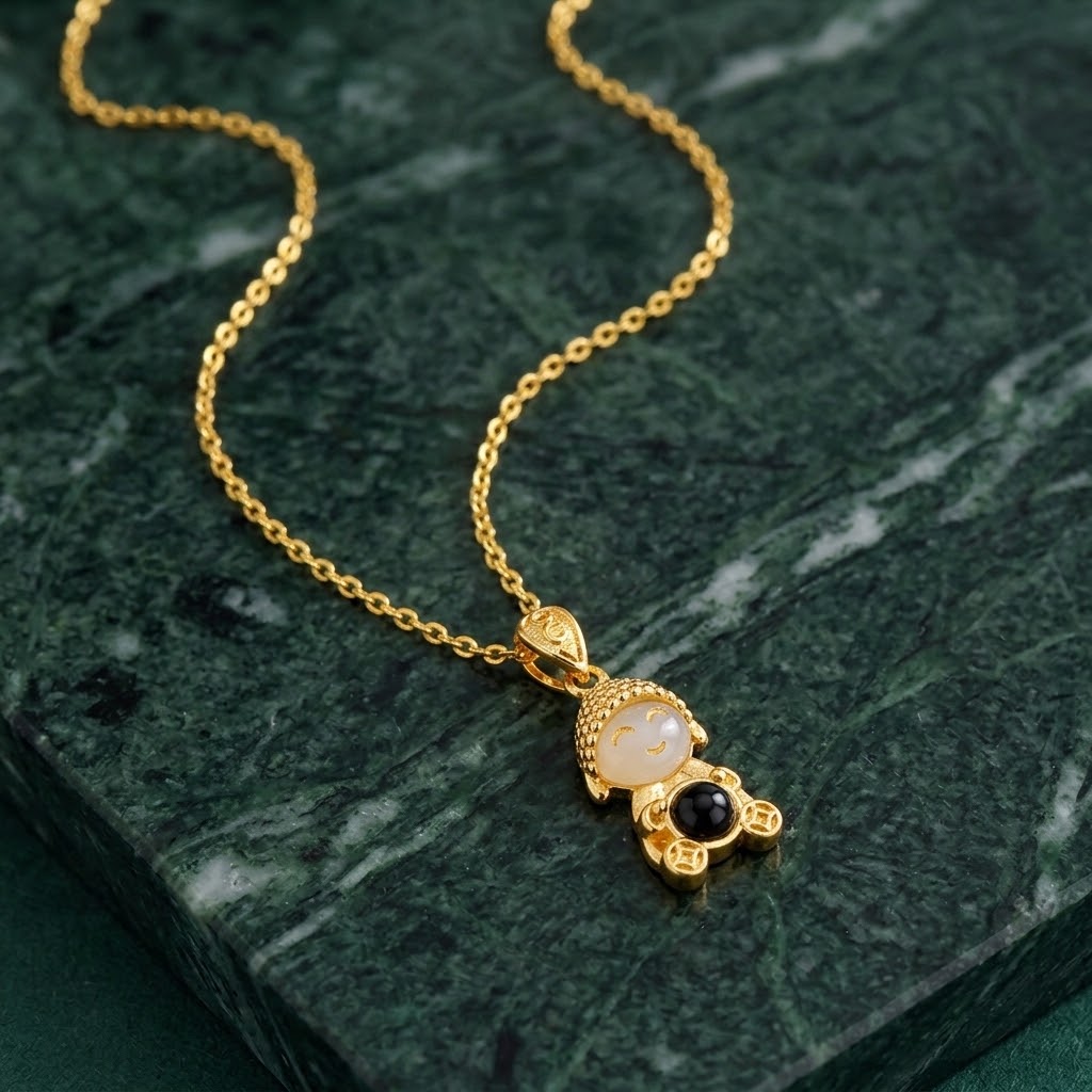 Gold chain doll pendant necklace with cream face and black round detail